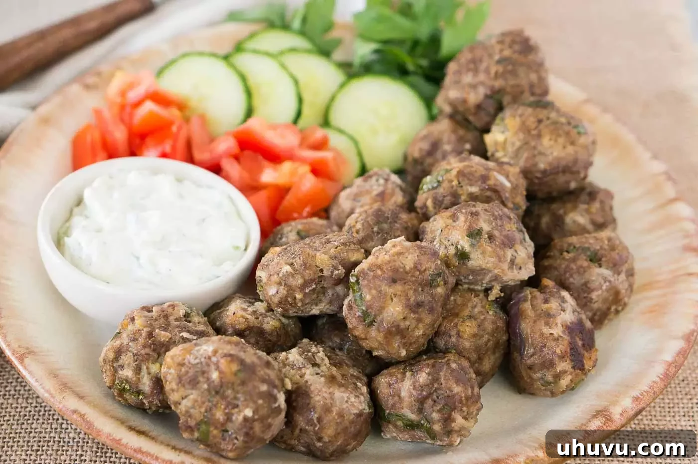 greek meatballs on a plate with vegetables