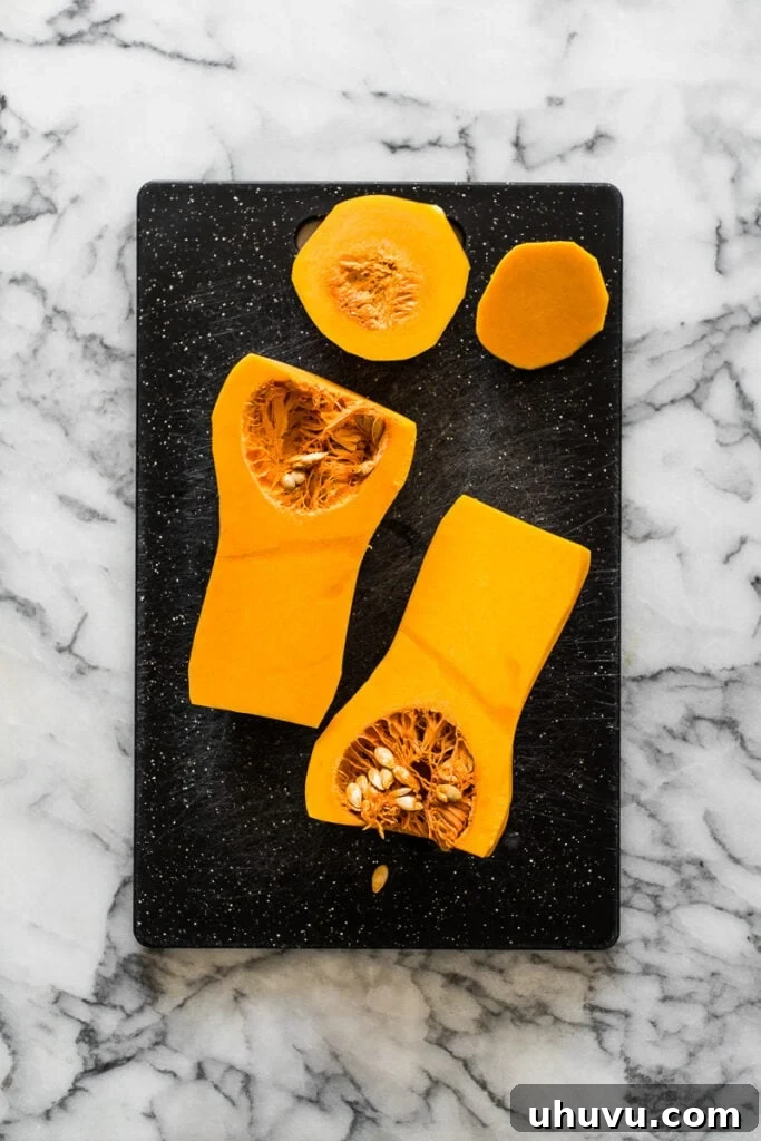 A butternut squash sliced in half lengthwise, showing the seed cavity.