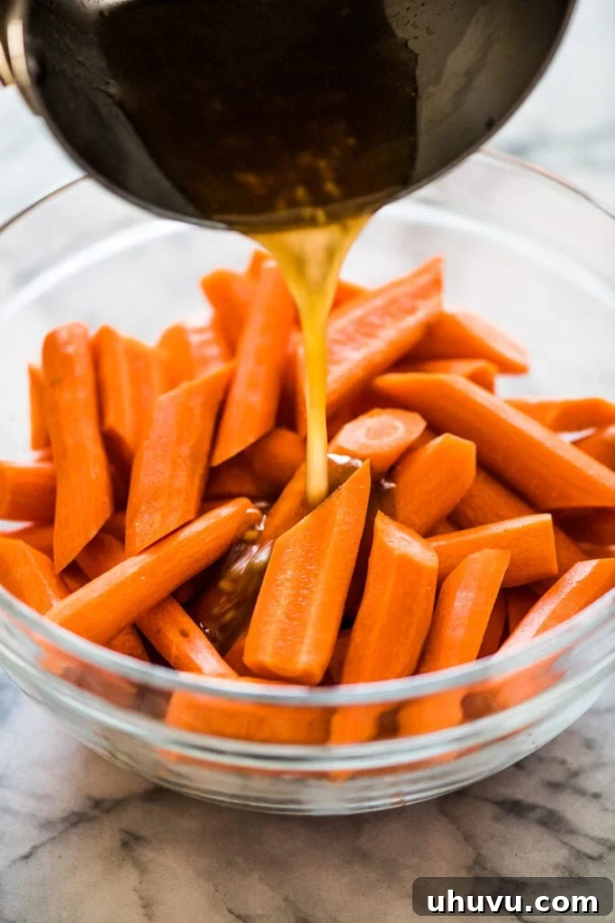 Glazed Maple Cinnamon Carrots 3 Peeled and uniformly sliced carrots in a mixing bowl, ready for seasoning.
