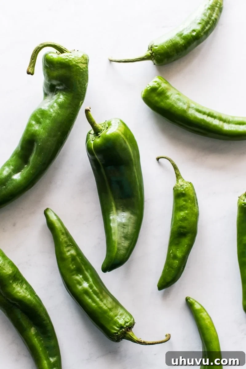 Anaheim Peppers Mild Heat Big Flavor 2 Fresh green Anaheim peppers on a rustic wooden surface