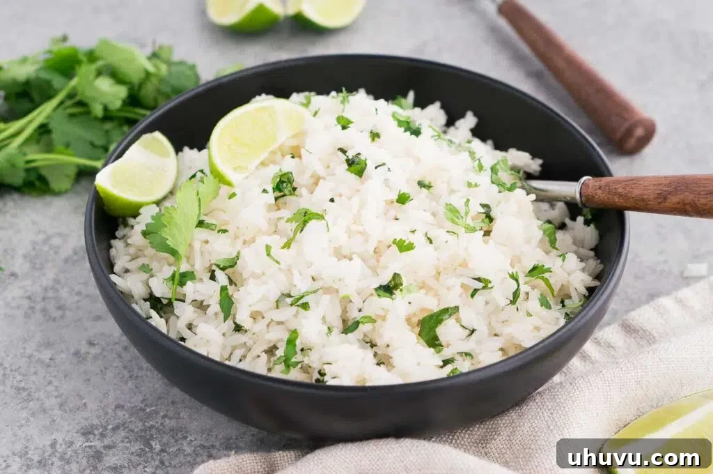 Close-up of fluffy cilantro and lime rice served in a rustic black bowl, ready to be enjoyed.