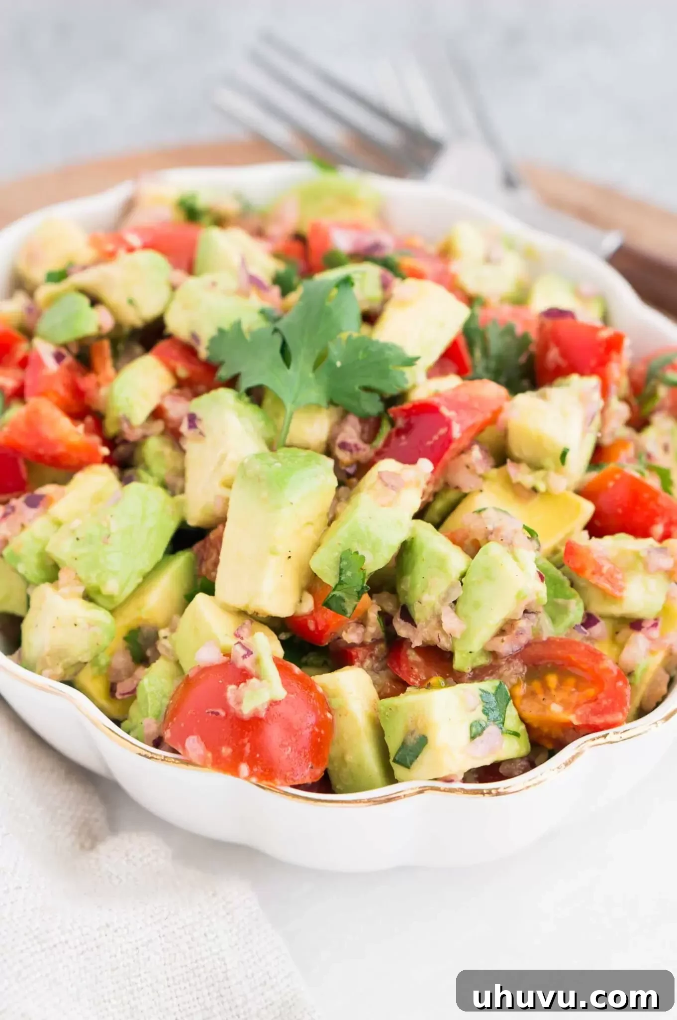 A vibrant bowl of avocado salsa with fresh herbs, ready for serving