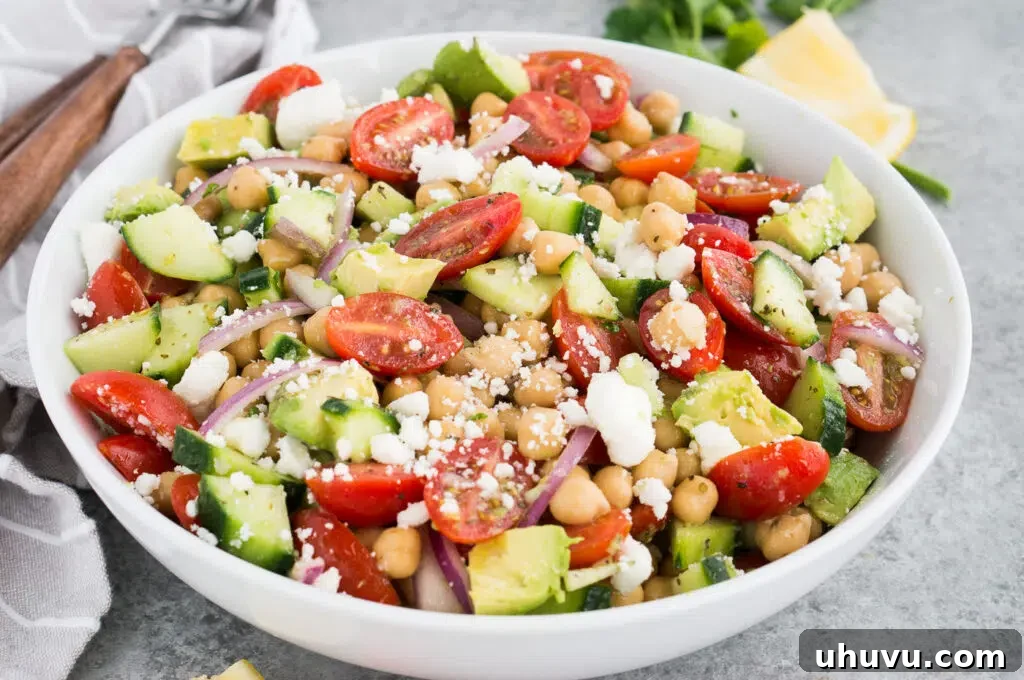 Overhead view of a vibrant chickpea salad recipe served in a large white bowl, ready to be enjoyed.