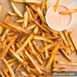 The best homemade french fries served on a board with dipping sauce