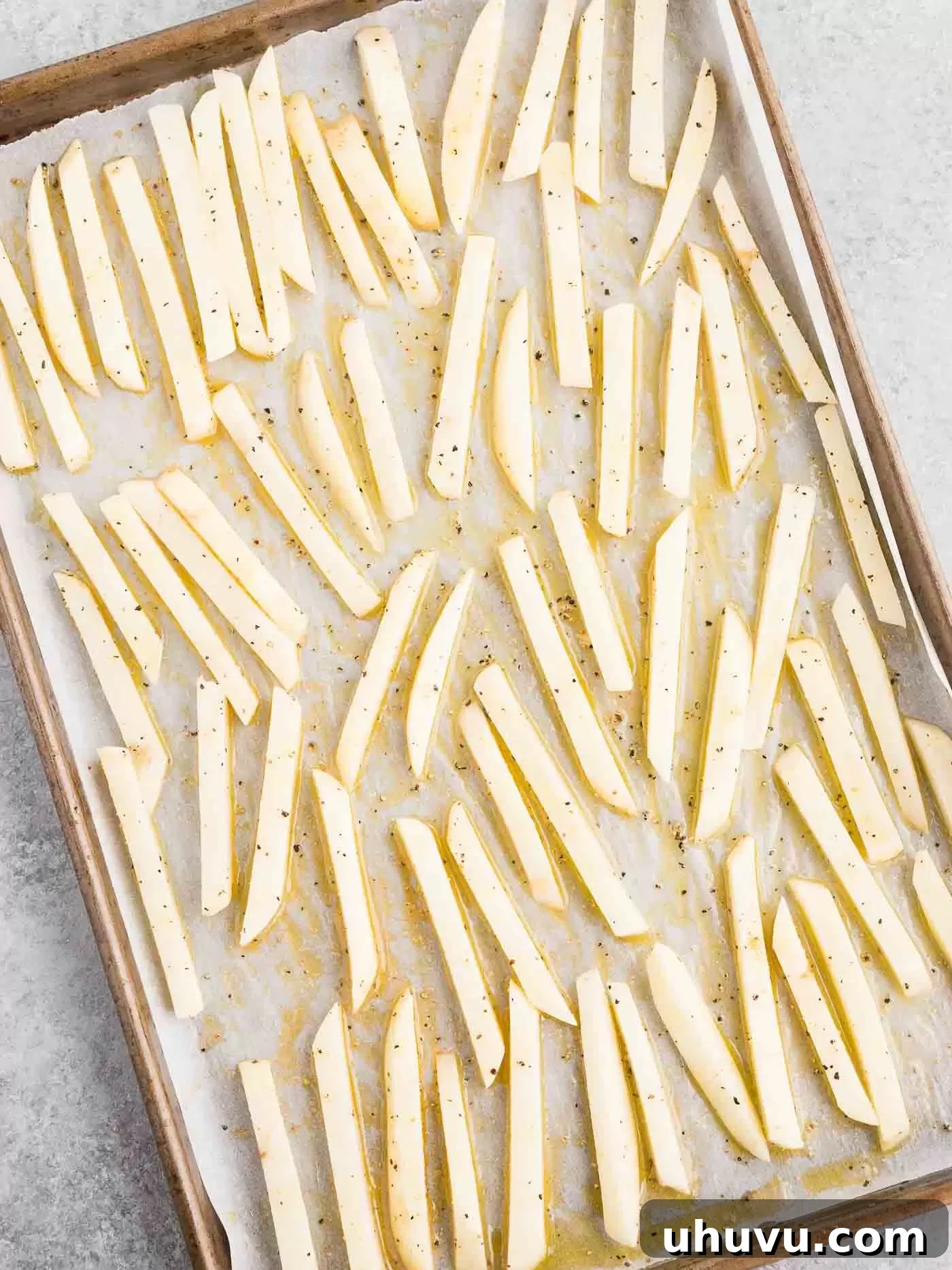Spread potato fries on a baking sheet before baking