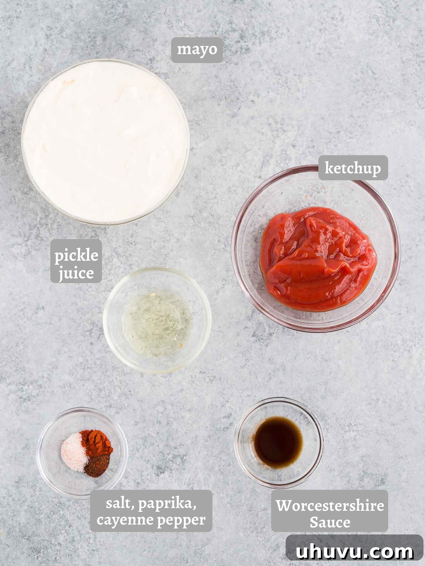 All the fresh and dry ingredients for homemade fry sauce laid out neatly: mayonnaise, ketchup, pickle juice, Worcestershire sauce, and a selection of spices.
