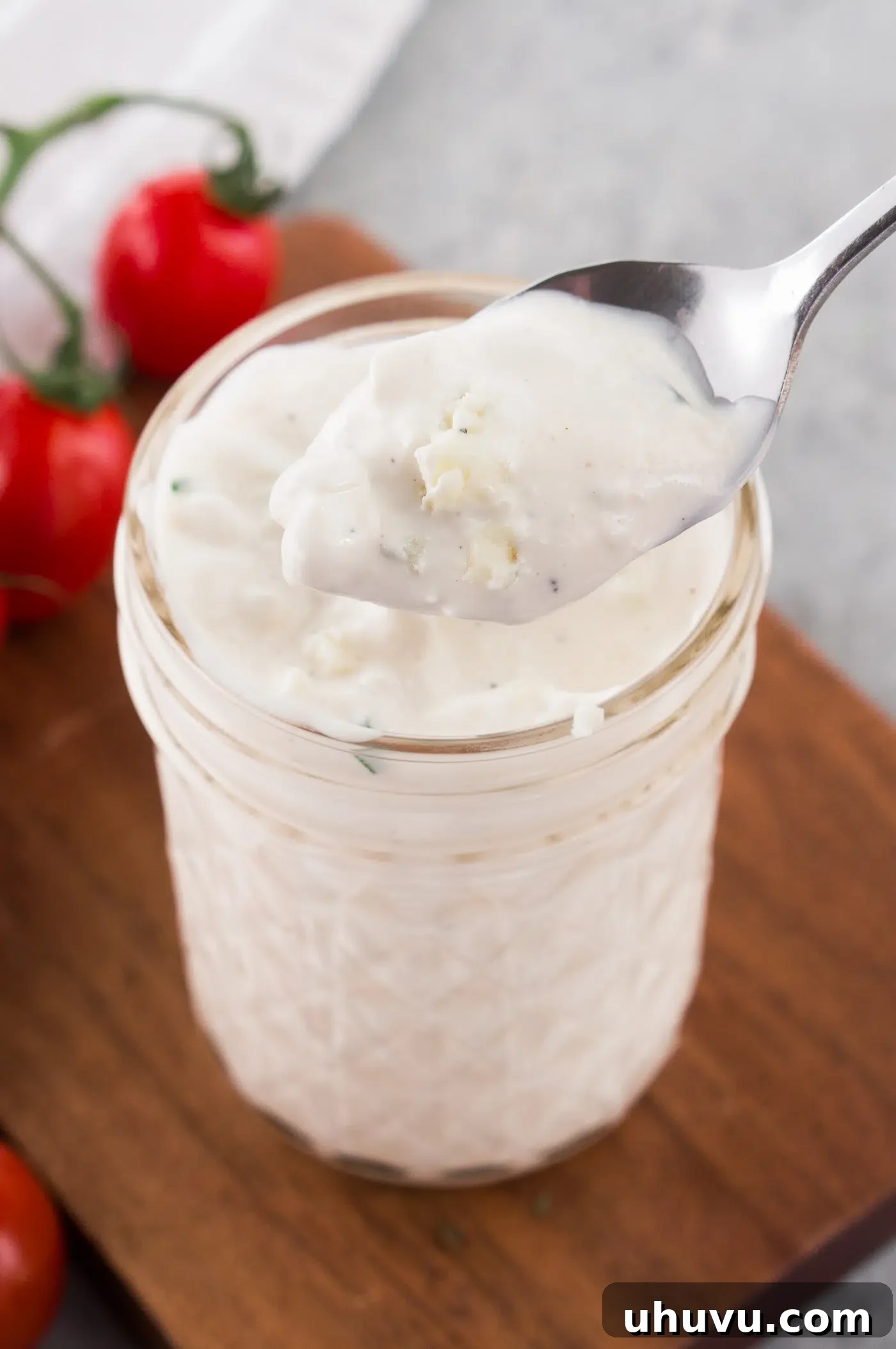 Easy blue cheese dressing or dip in a glass jar, garnished with chives