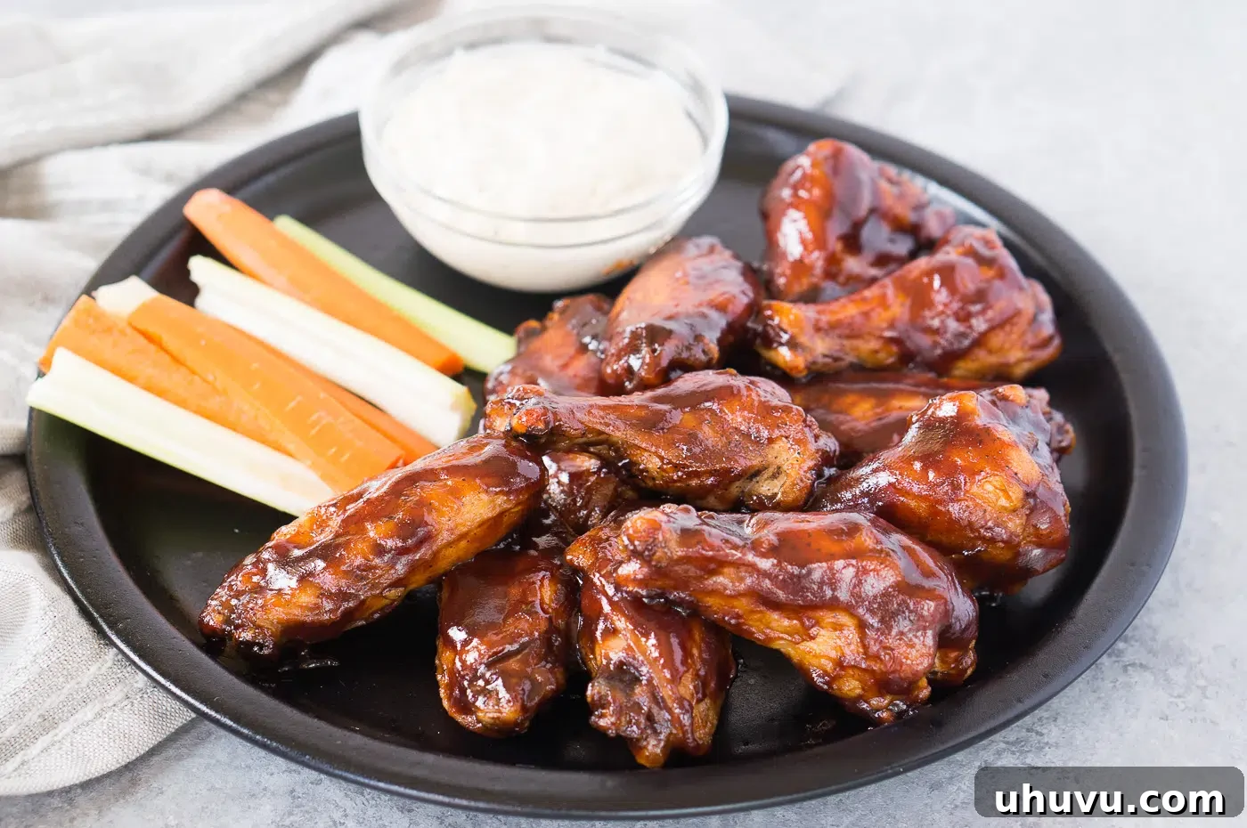 Baked chicken wings coated in barbecue sauce, close up