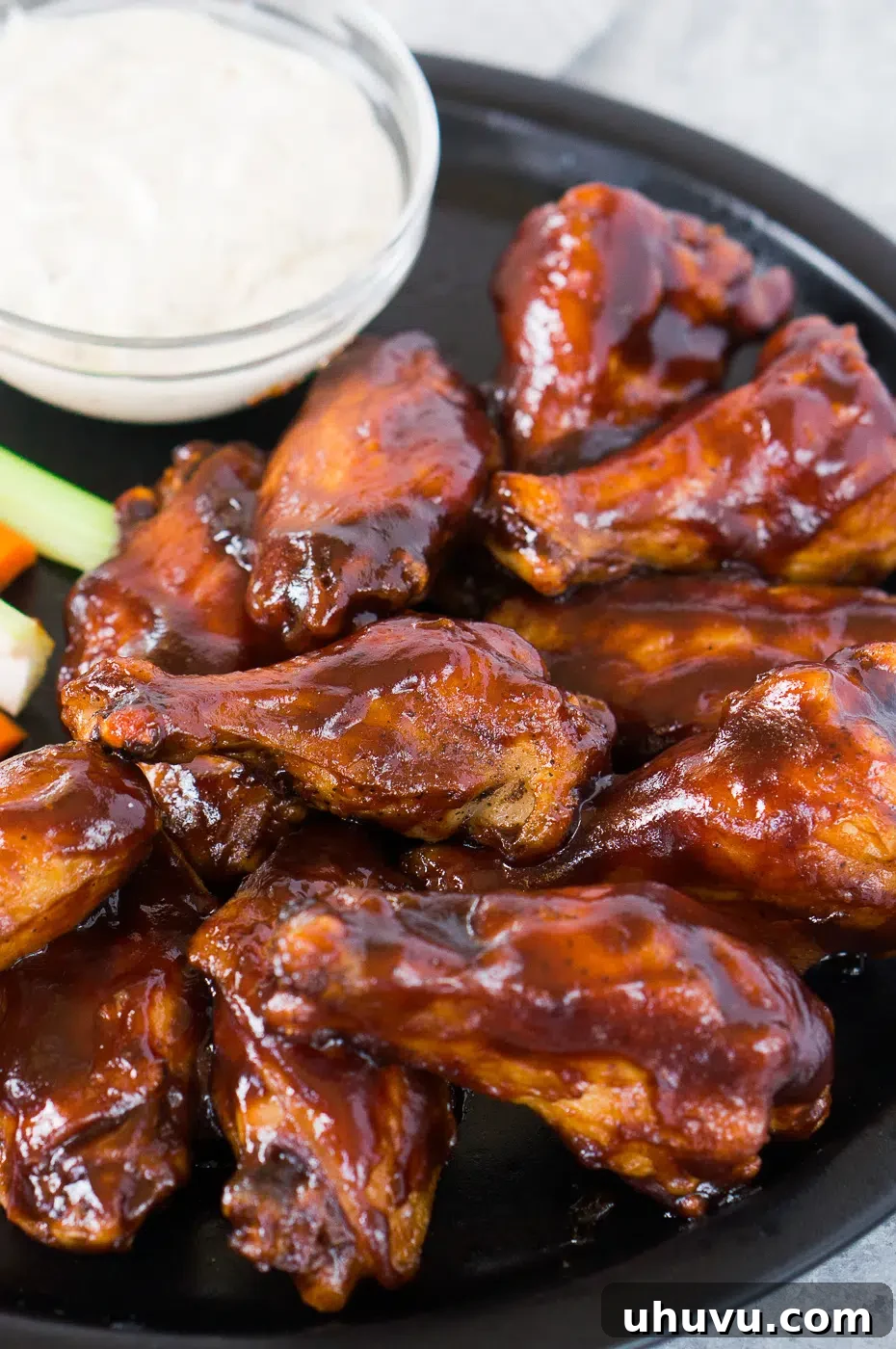 Close up shot of BBQ baked chicken wings recipe, showcasing the sticky glaze