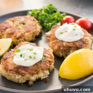 crab patties with tartar sauce on a plate