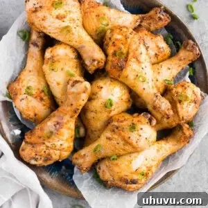 Oven fried chicken legs on a plate, representing the final delicious dish.