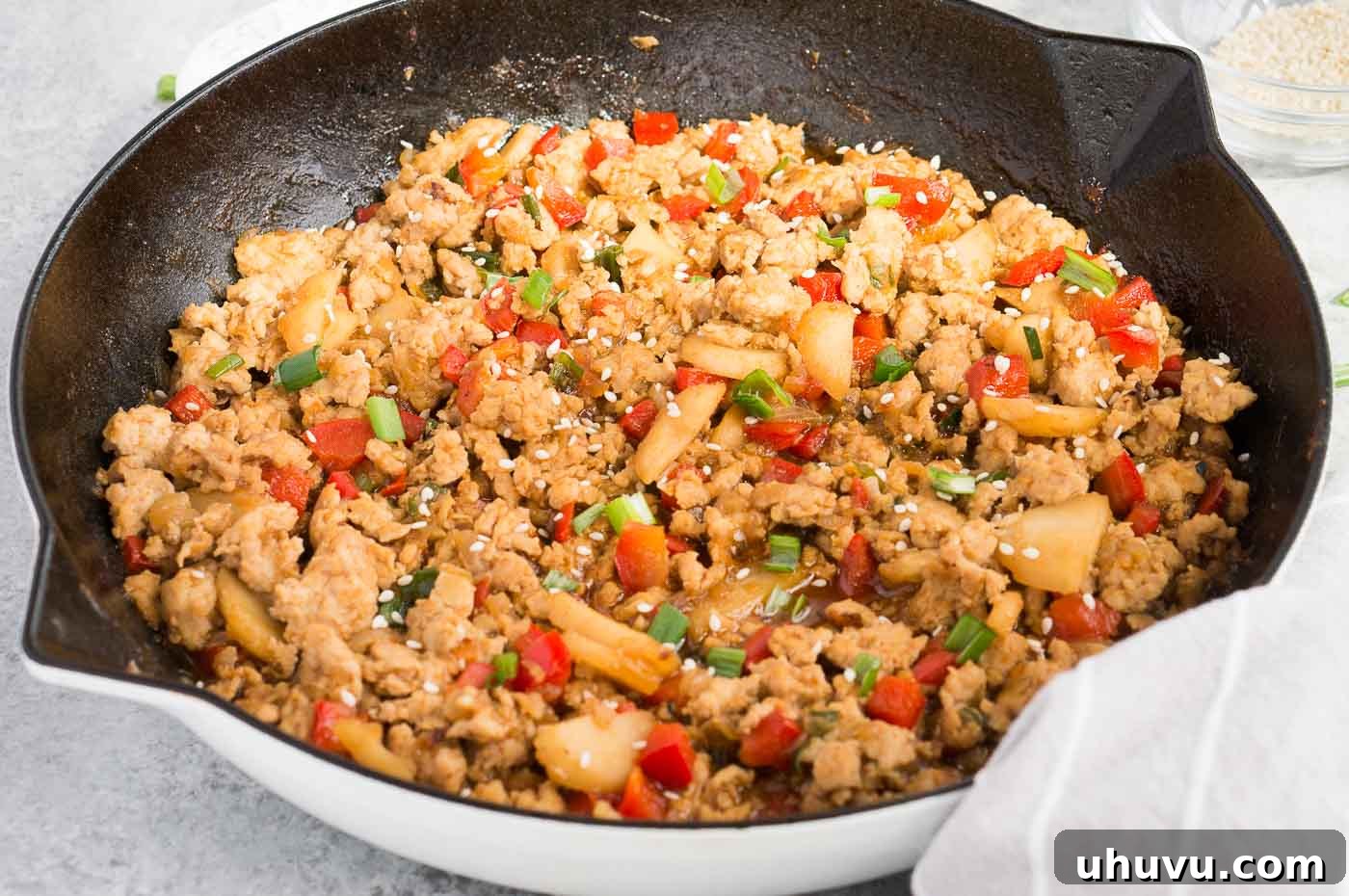 Crispy Chicken Lettuce Cups 3 Close up image of an Asian chicken filling cooking in a skillet, showcasing its rich texture and vibrant colors