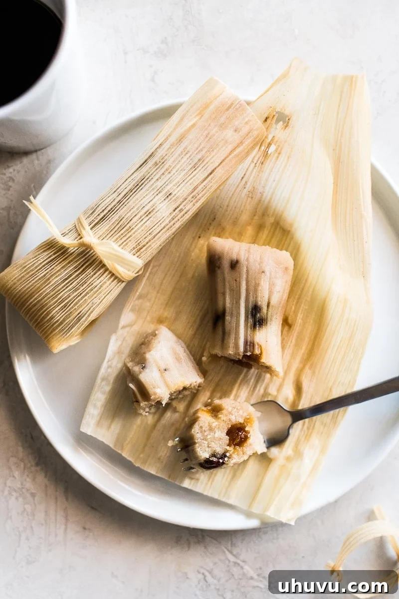 Sweet Corn Delights 2 Sweet tamales on a corn husk filled with raisins.