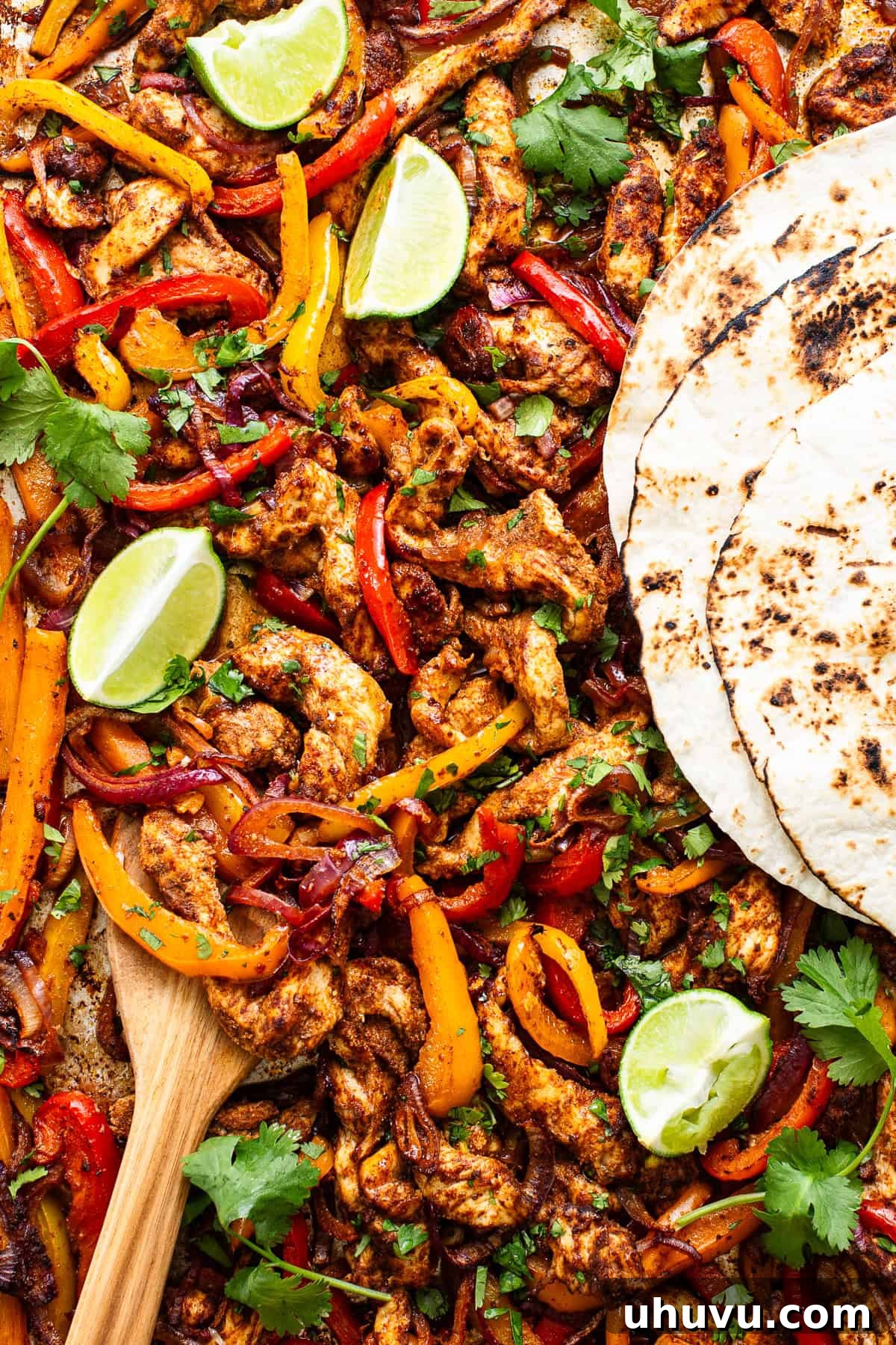Sizzling Sheet Pan Chicken Fajitas 2 Sheet pan chicken fajitas with tortillas ready to eat.