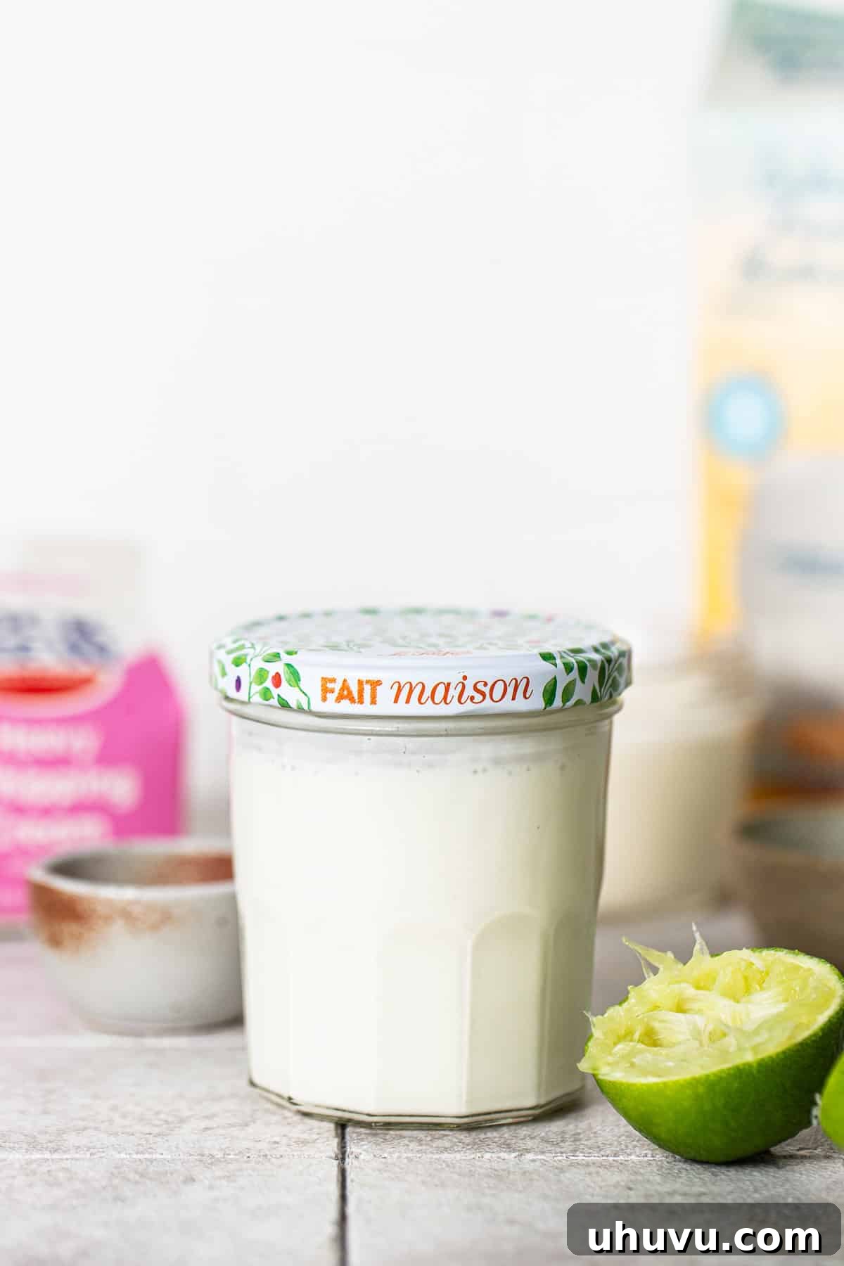 Mexico's Creamy Secret 4 Mexican crema mixture in a jar with a lid, prepared for fermentation.