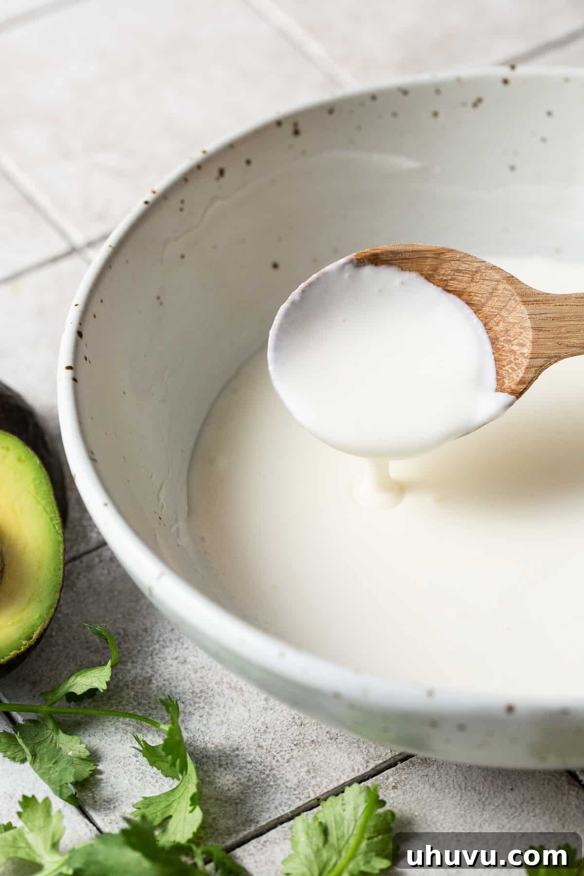 Mexican crema in a bowl with a spoon, ready to be served.