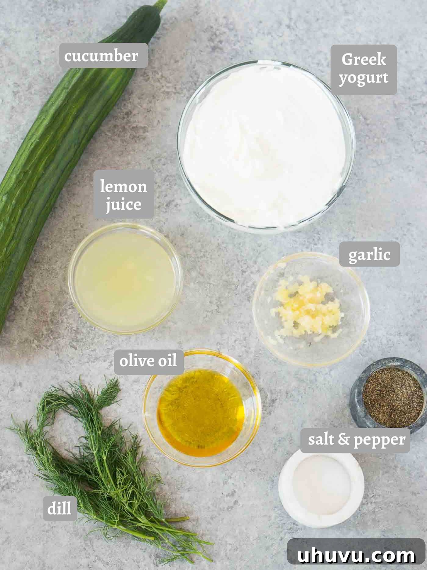 Zesty Greek Cucumber Sauce 4 All the fresh ingredients laid out for making Tzatziki sauce: Greek yogurt, cucumbers, garlic, dill, lemon, and olive oil.