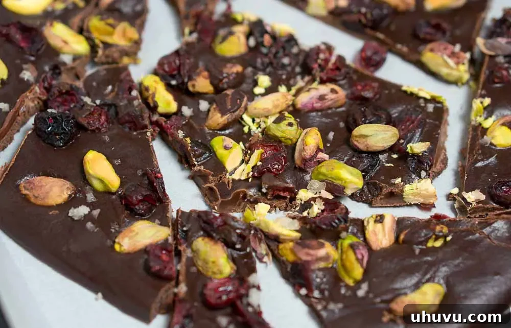 cranberry pistachio chocolate bark with vibrant red cranberries and green pistachios on a dark chocolate base