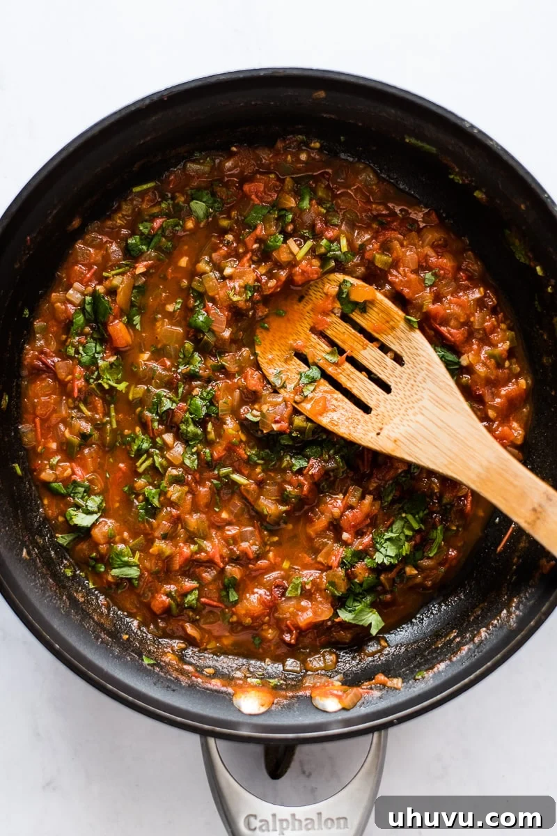 Zesty Ranchero Sauce 4 Ranchero sauce ingredients simmering in a large skillet.