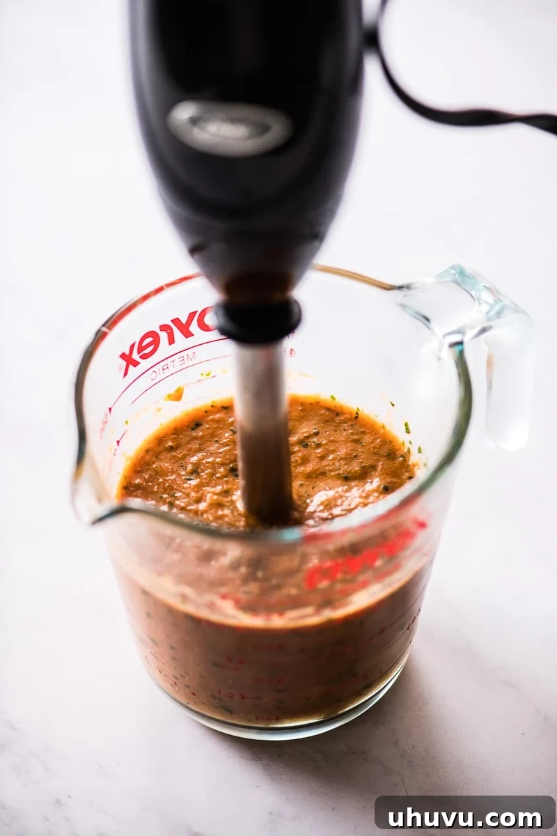 Zesty Ranchero Sauce 5 Ranchero sauce being blended to a smooth consistency in a blender.