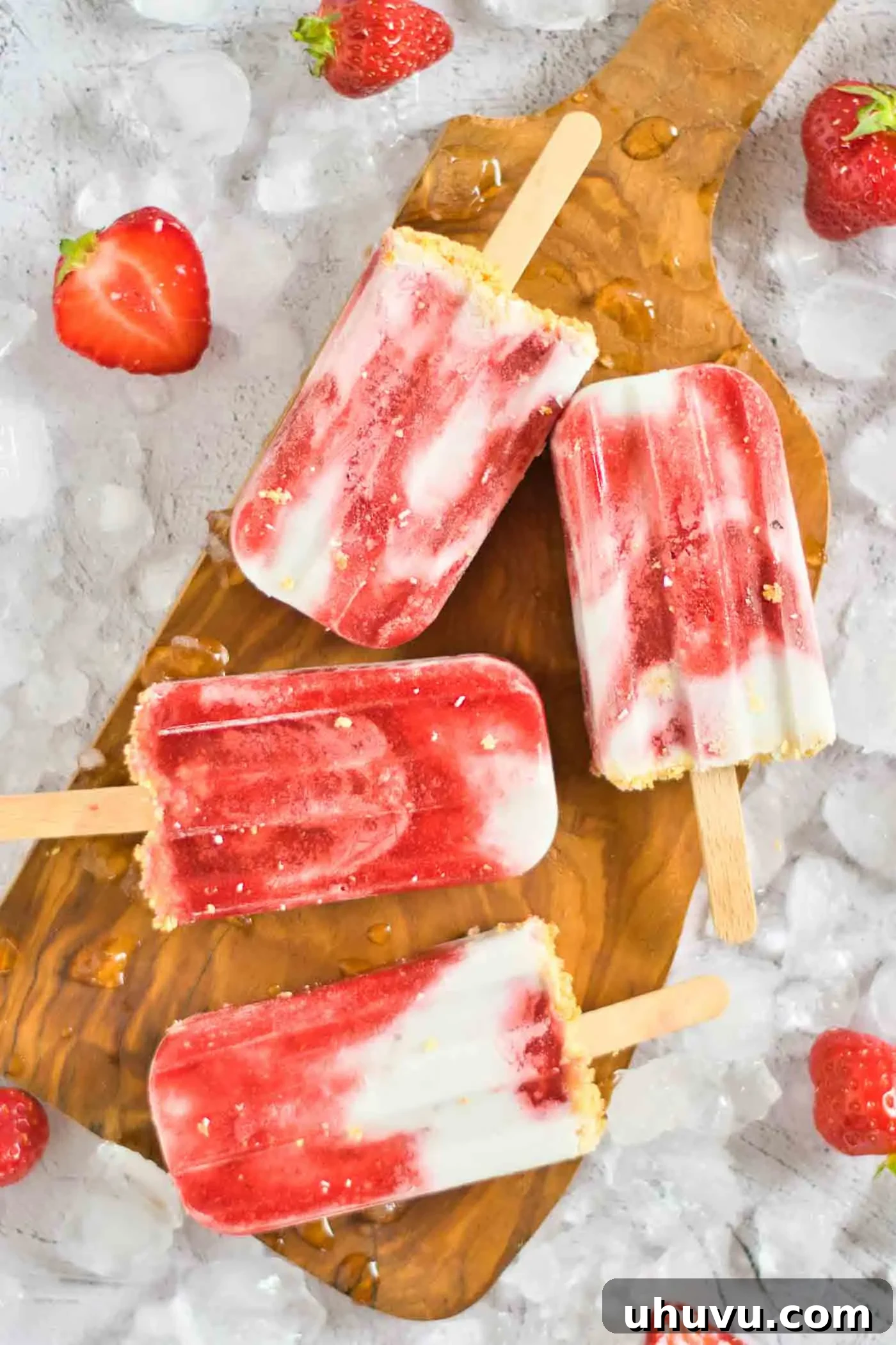close up of cream popsicles on ice cubes