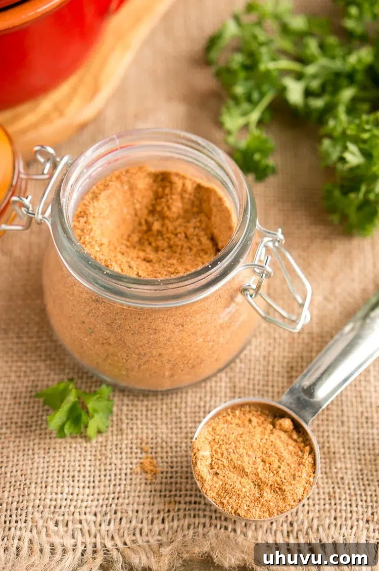 Ultimate Homemade Taco Spice Blend 2 A jar of homemade taco seasoning with various spices in the background, ready for use in a flavorful meal.