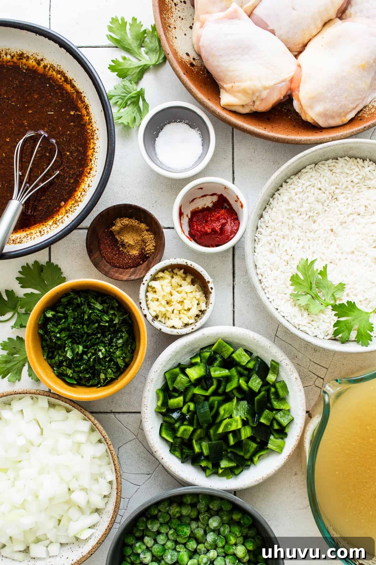 Arroz con pollo ingredients separated and measured into mixing bowls