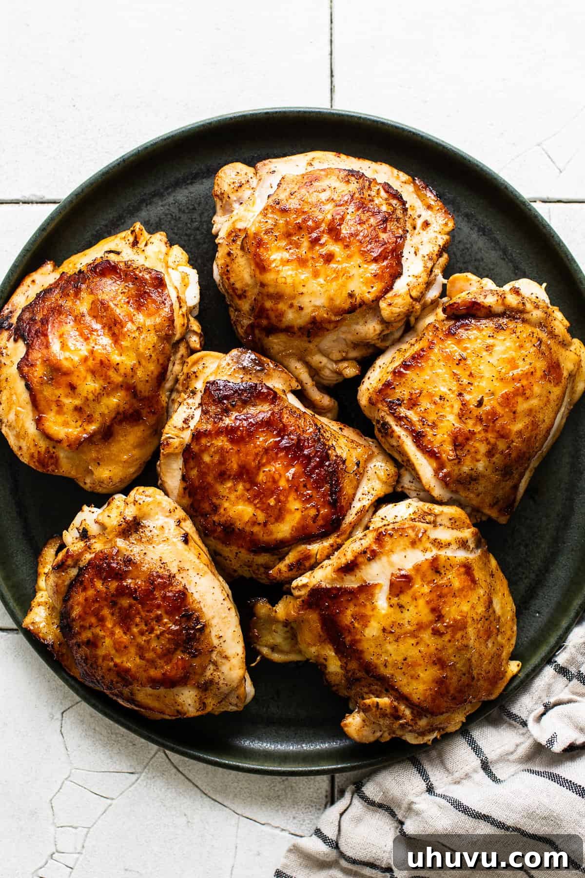Browned chicken thighs on a platter
