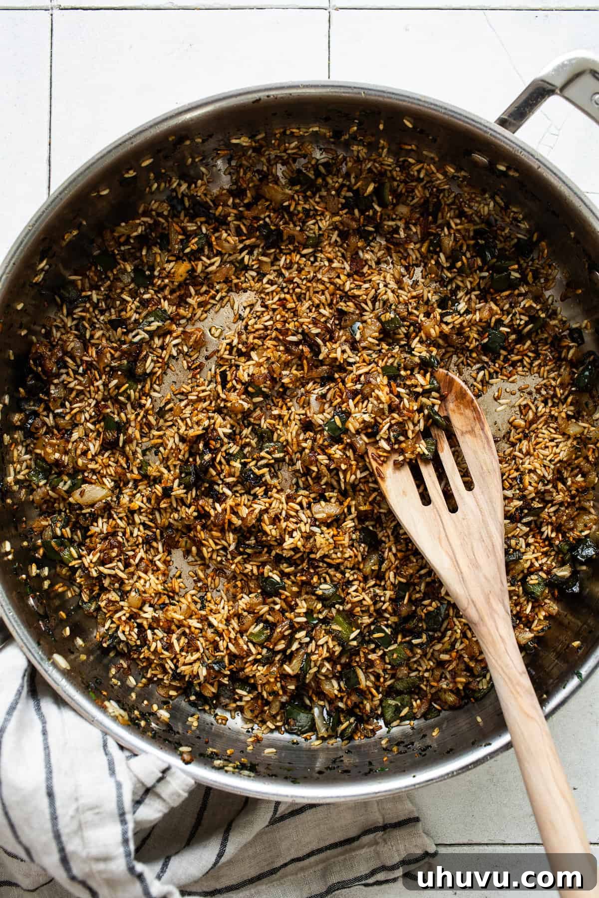 Browning the rice until light brown colored