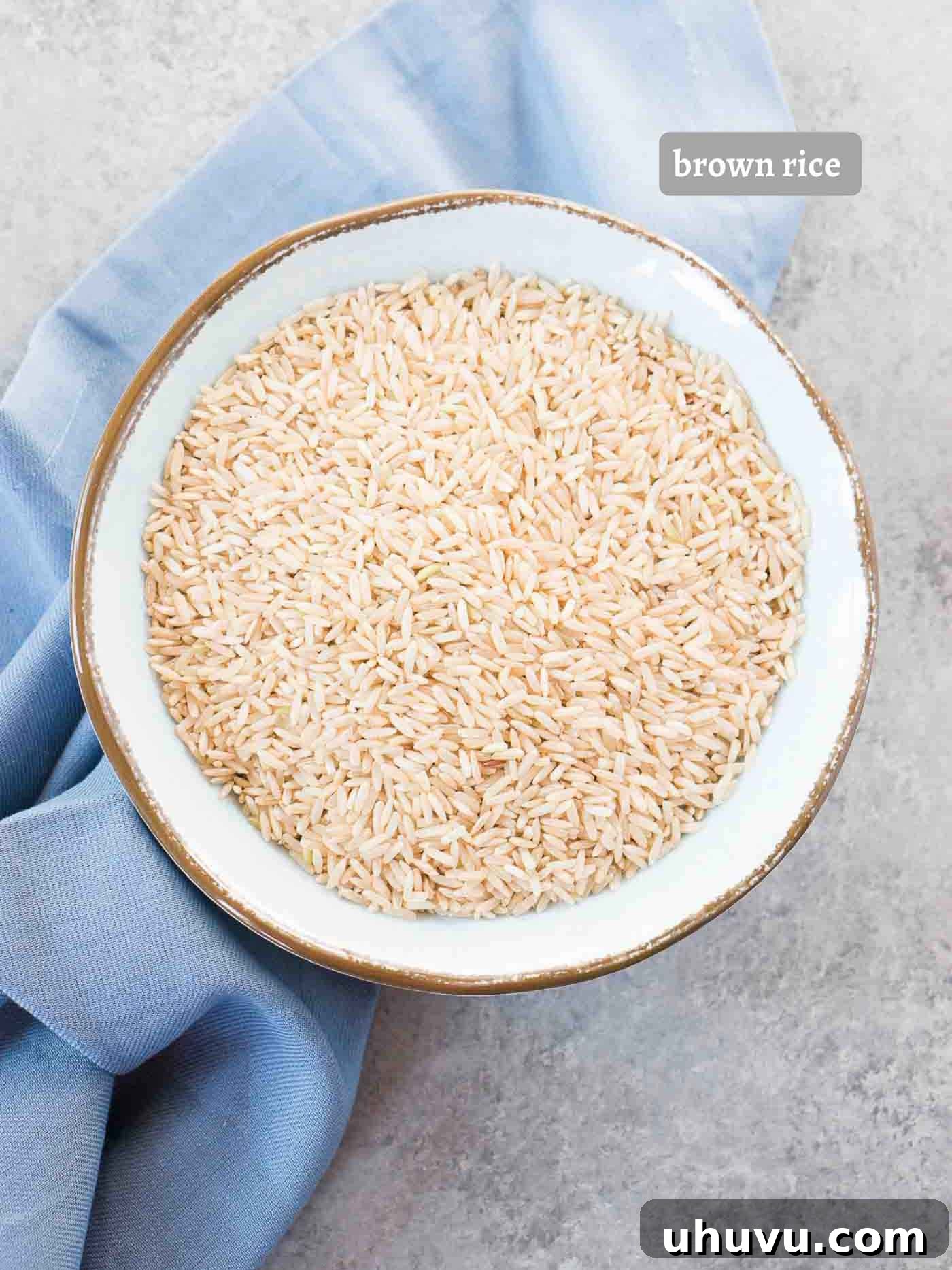Perfect Fluffy Instant Pot Brown Rice 4 Uncooked brown basmati rice in a wooden bowl, ready for preparation.