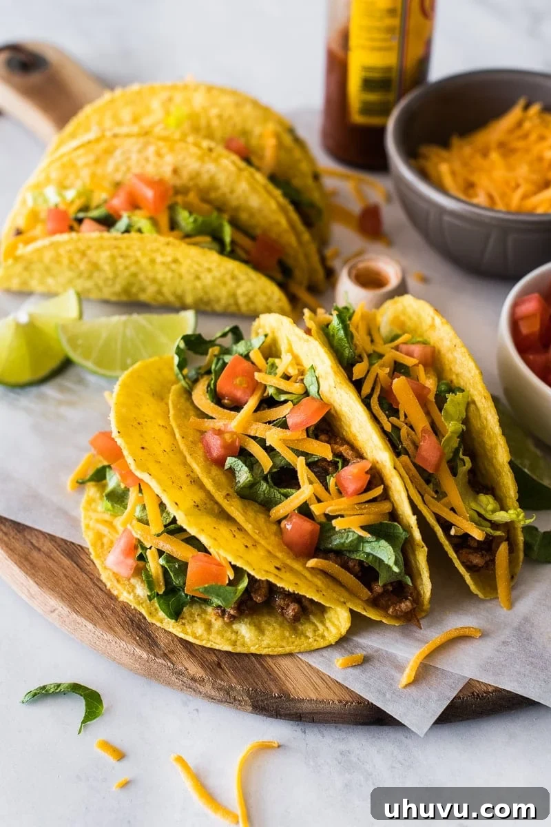Golden Crispy Tacos 2 Hard shell tacos topped with lettuce, cheese and tomatoes.