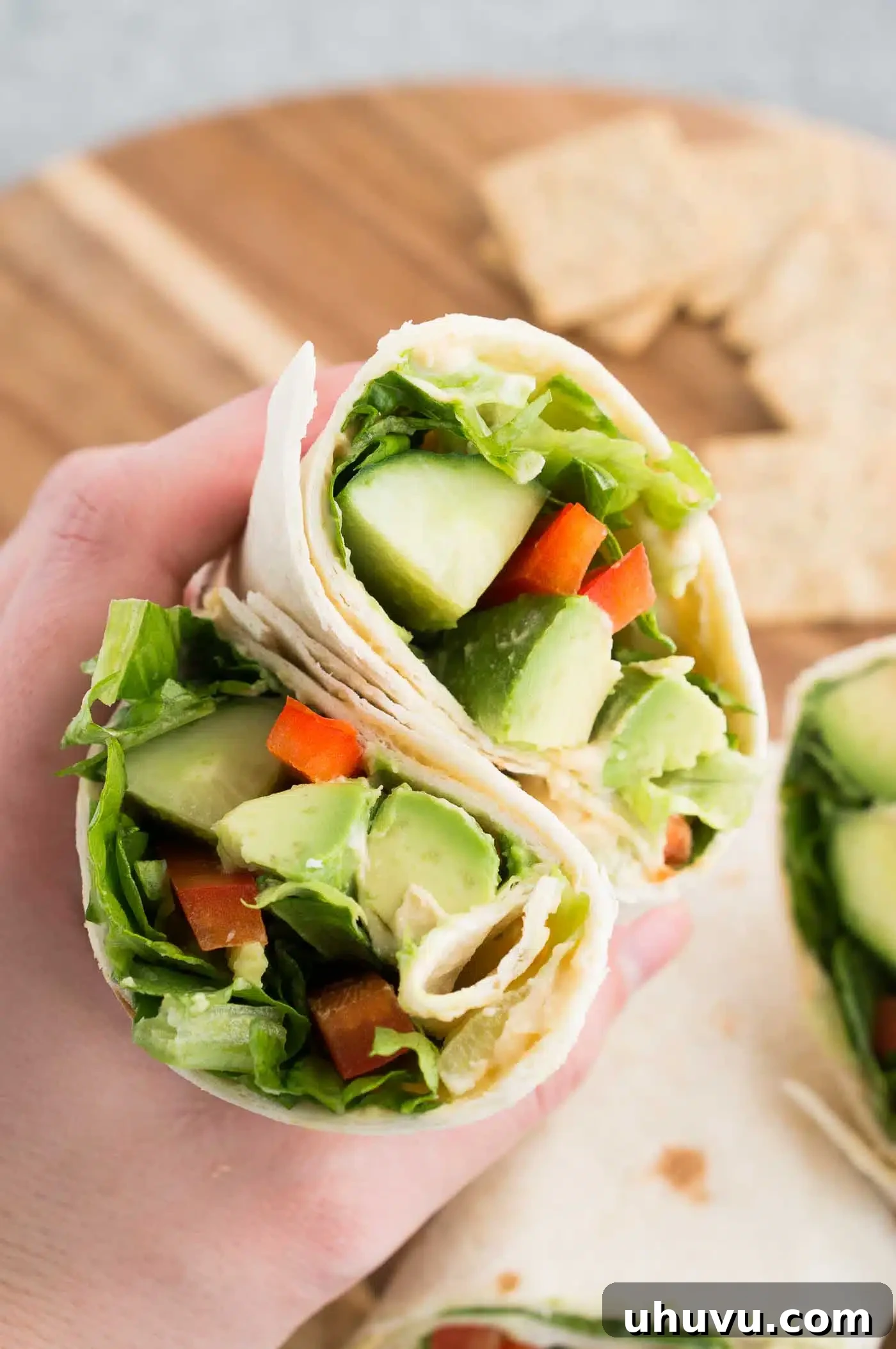 Vibrant Veggie Wrap 6 holding a vegan wrap sliced in half