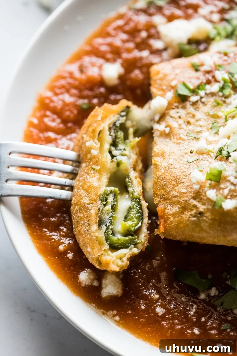 Authentic Chile Relleno from Scratch 3 A chile relleno sliced open, revealing the luxurious stream of melted cheese within its perfectly cooked interior.