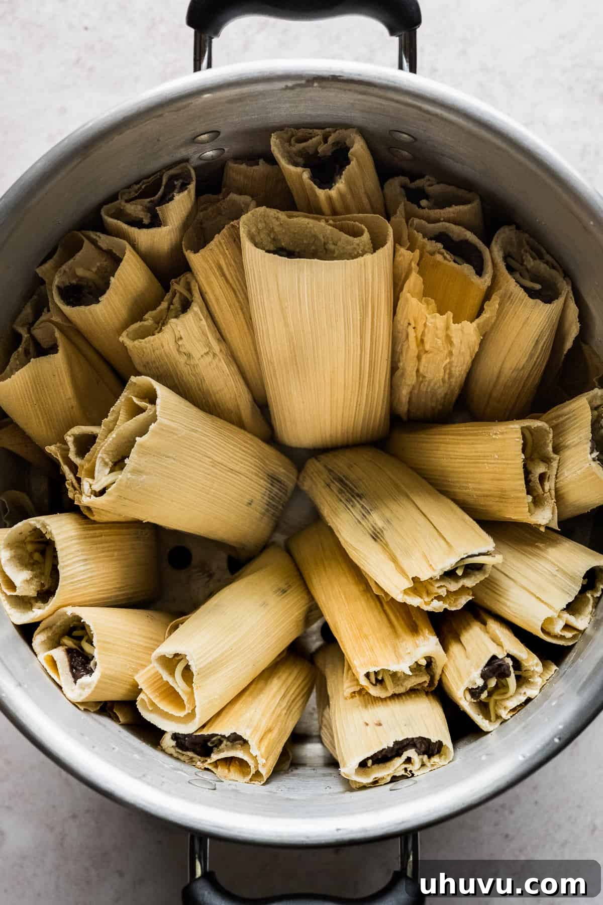 25 Quick Bean Dinners 16 A large tamale steamer pot, beautifully arranged with numerous Bean and Cheese Tamales, ready to be enjoyed.