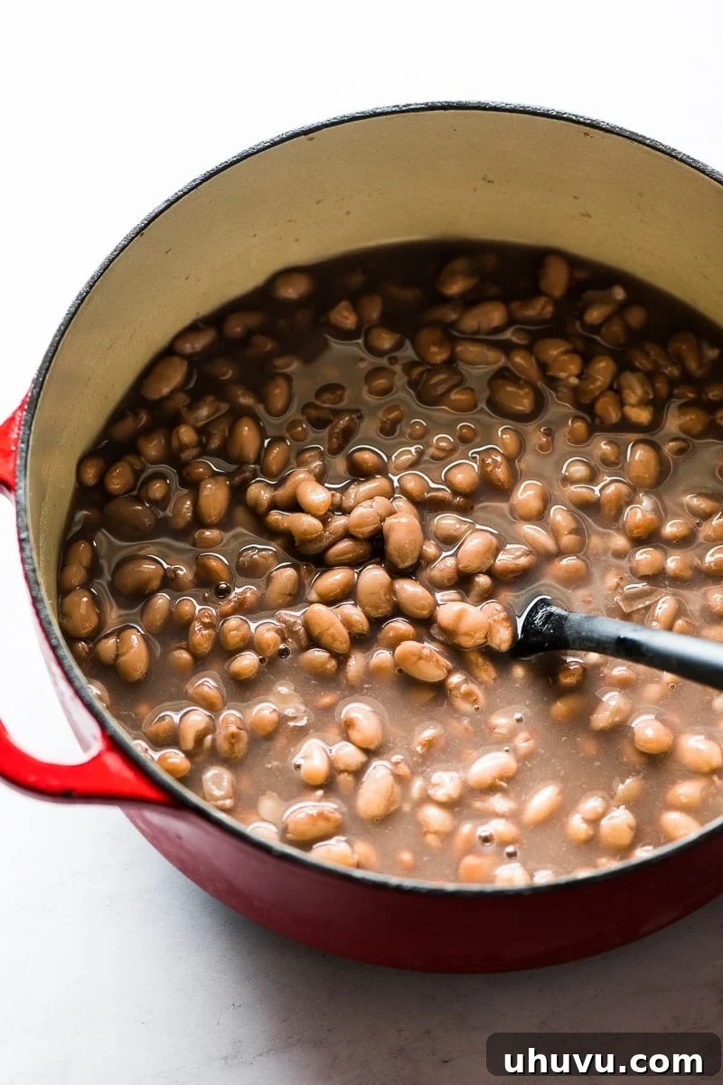 25 Quick Bean Dinners 24 A pot of perfectly cooked pinto beans, showcasing their creamy texture.