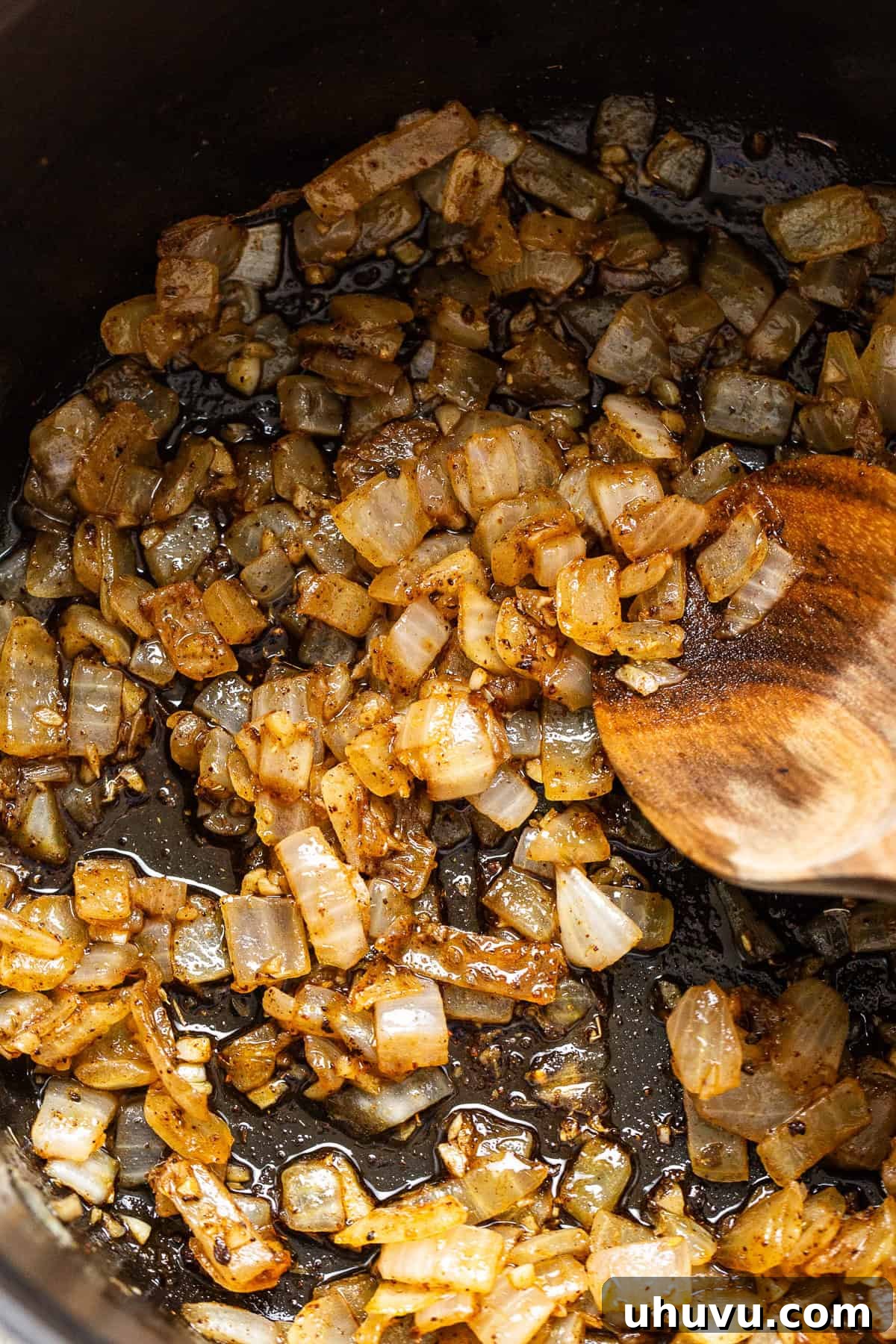Sautéed onions and seasonings in a pot.