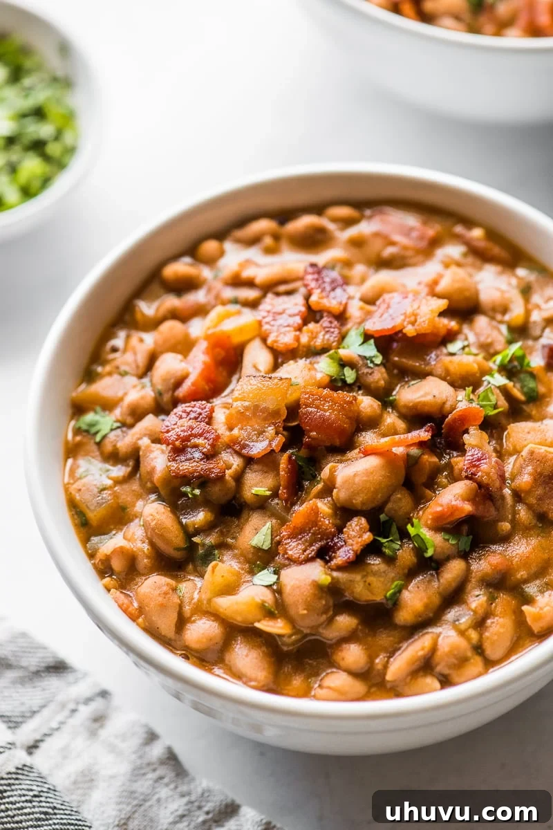 Beer-Braised Fiesta Beans 8 Crispy bacon bits generously sprinkled on top of a serving of borracho beans, adding a delightful crunch and smoky flavor.