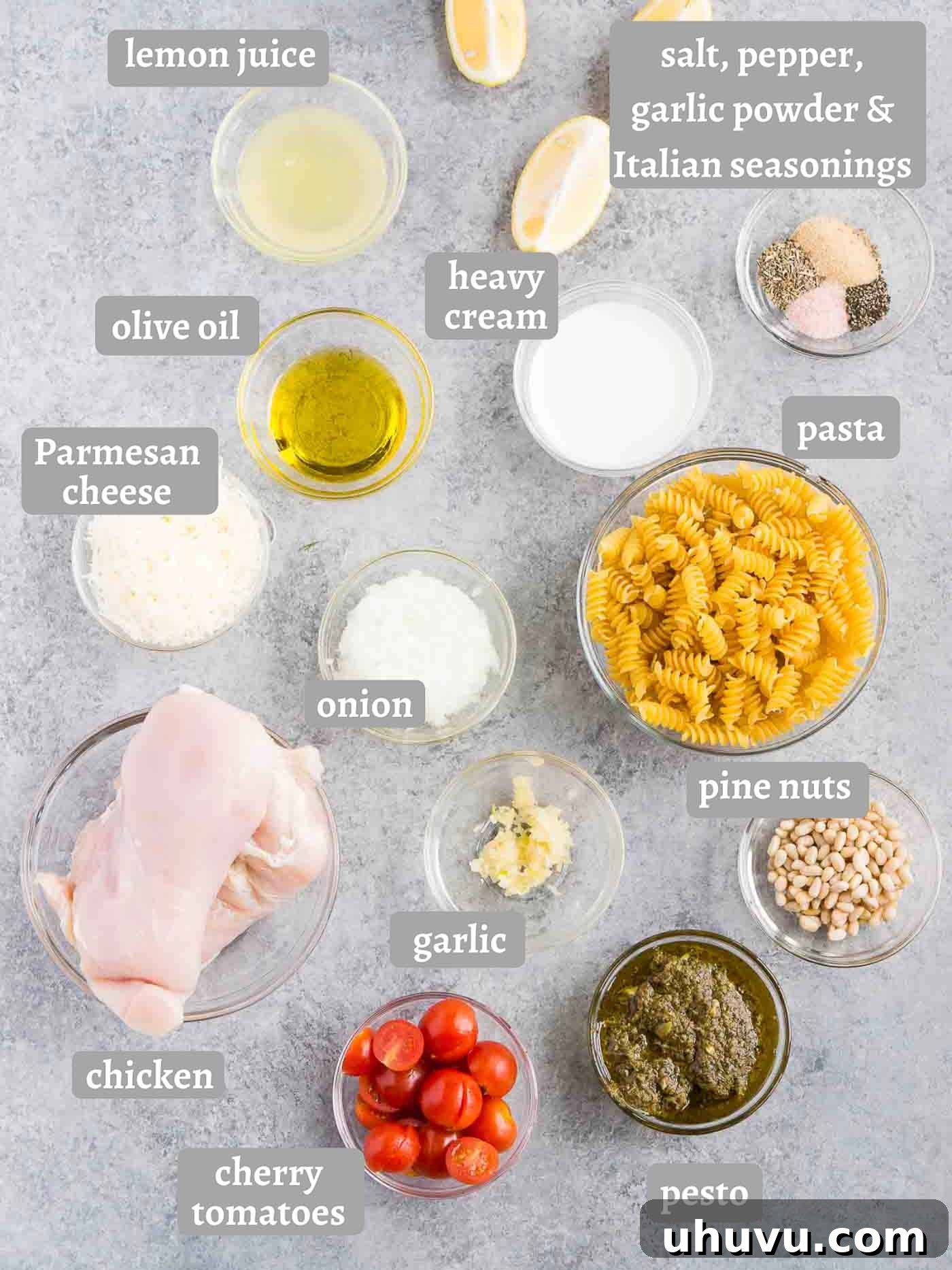 A collection of ingredients for making chicken pesto pasta