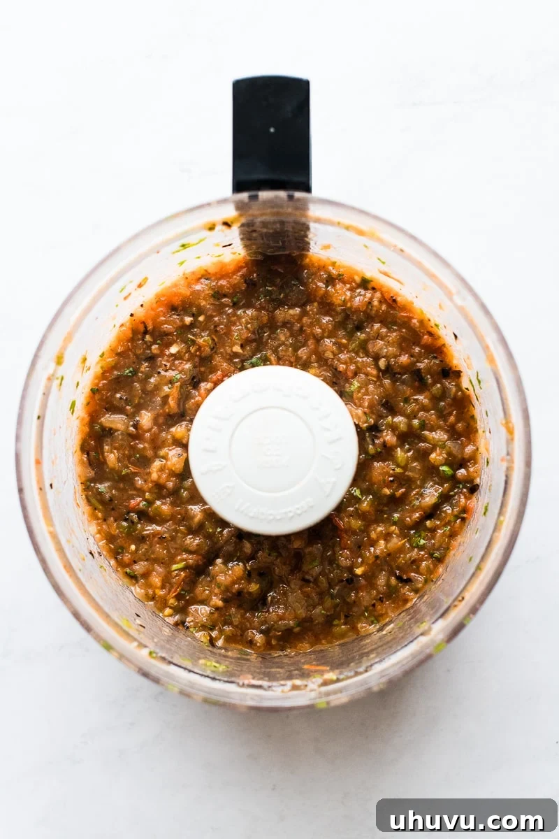 Fire-Roasted Tomato Salsa 5 A beautiful bowl of freshly made roasted tomato salsa, garnished with cilantro, ready to be served with crispy tortilla chips.