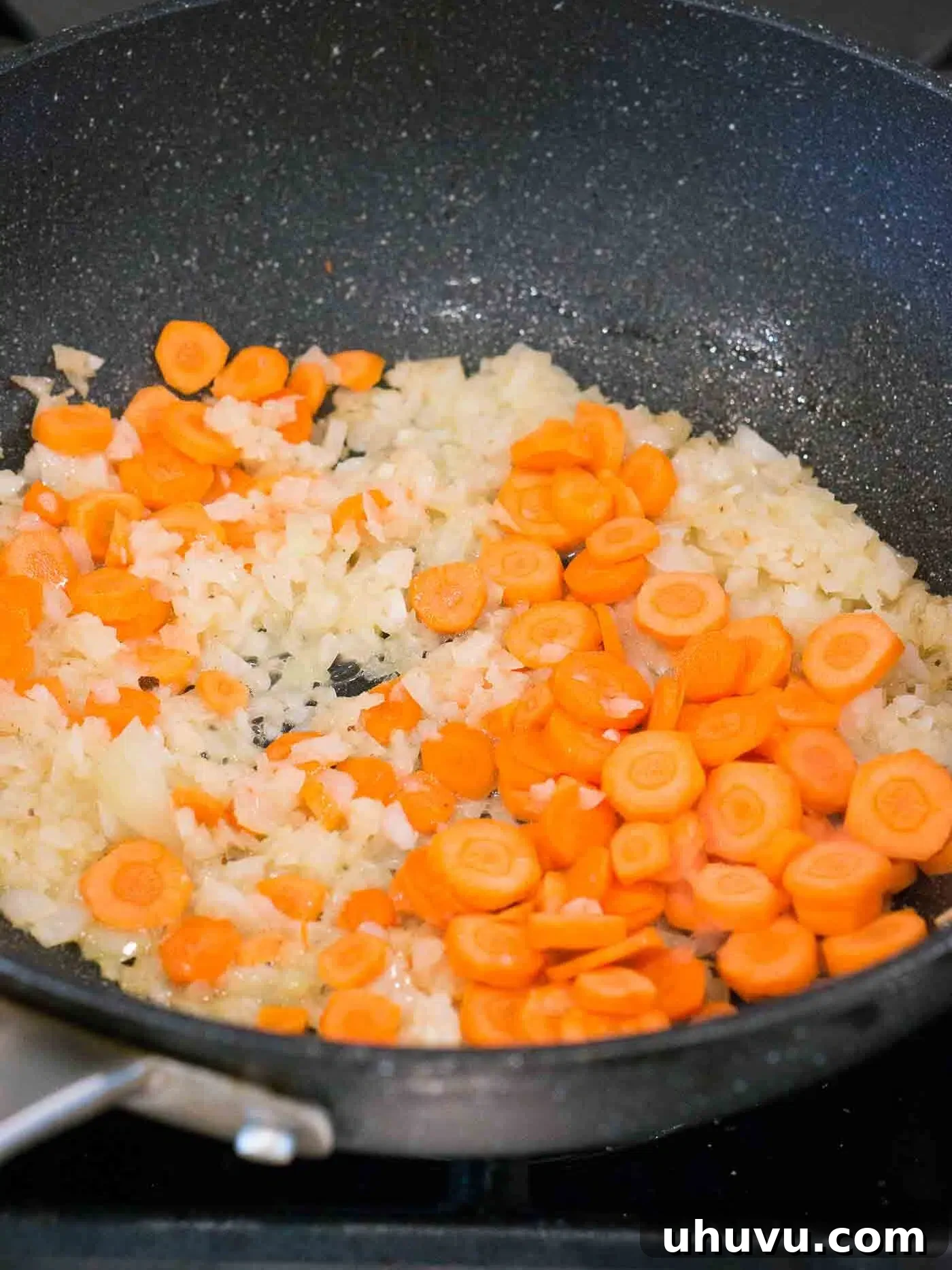 Wok-Fired Beef Rice 6 Sautéing onions and carrots with garlic and ginger in a skillet