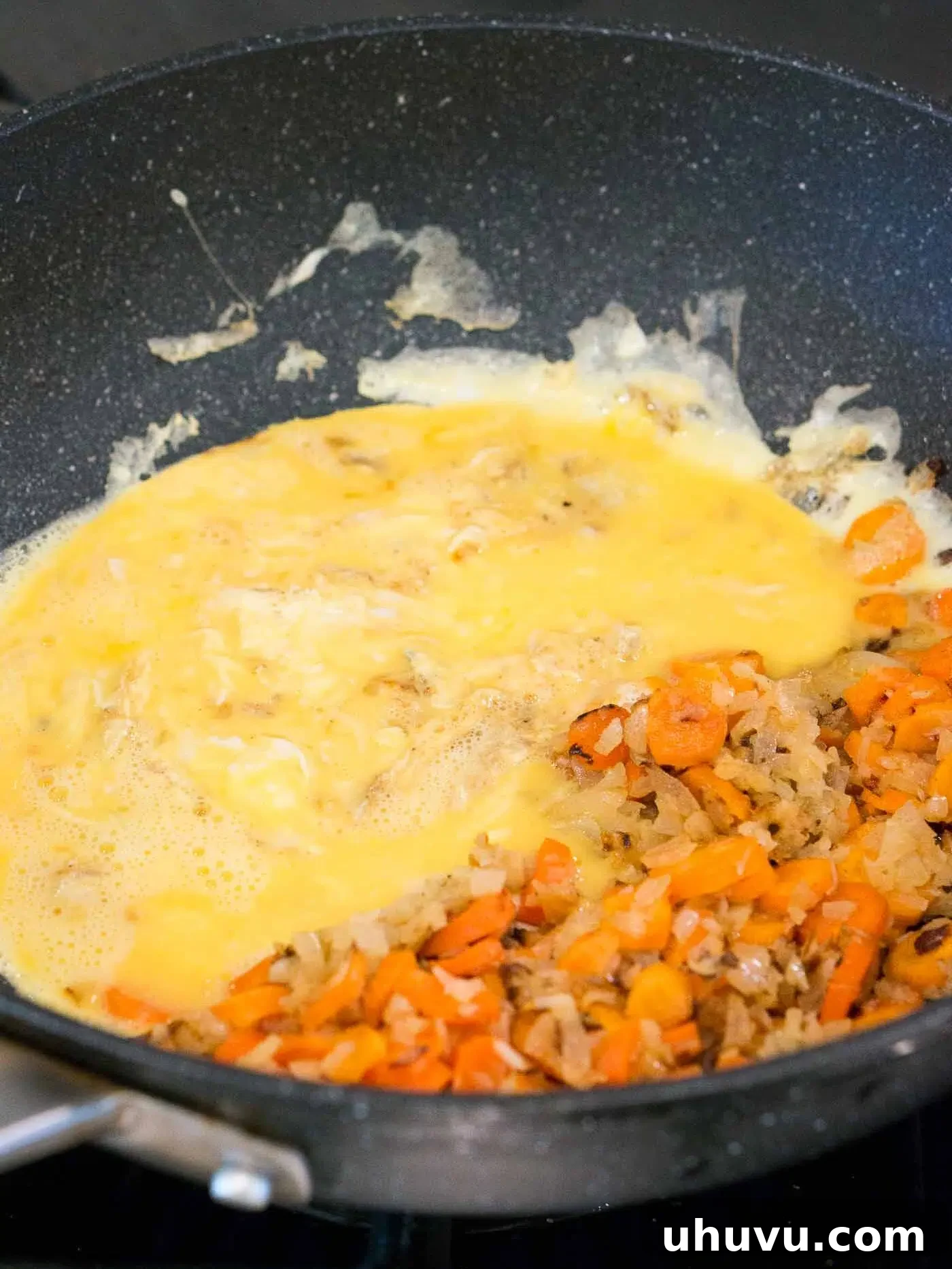 Wok-Fired Beef Rice 7 Scrambling eggs with sautéed vegetables in a skillet