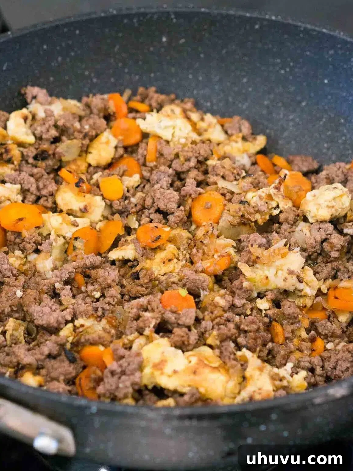 Wok-Fired Beef Rice 8 Adding cooked beef, soy sauce, sesame oil, and chili flakes to the skillet