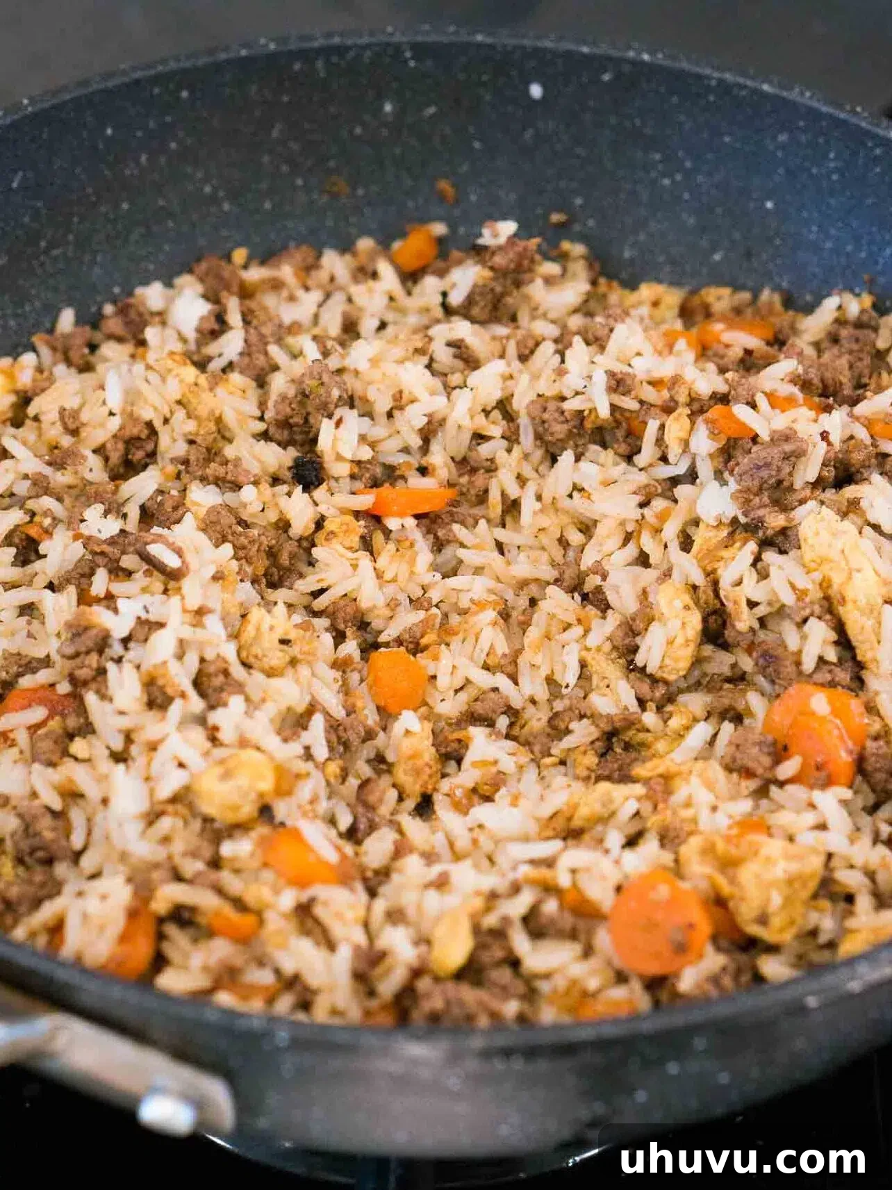 Wok-Fired Beef Rice 9 Adding cooked rice to the skillet with beef, vegetables, and seasonings