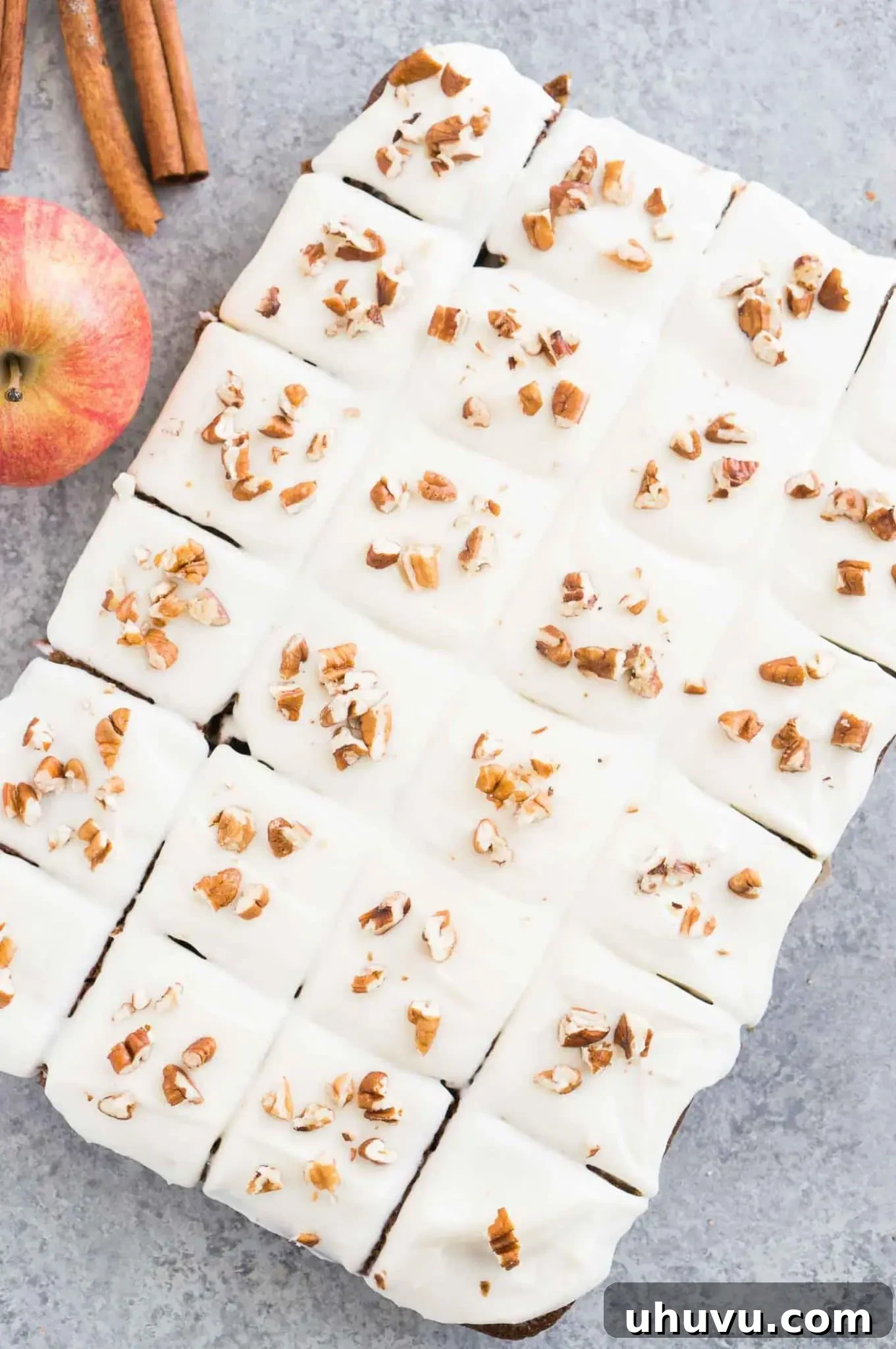 Fully frosted applesauce cake, sliced into squares, ready to be served.