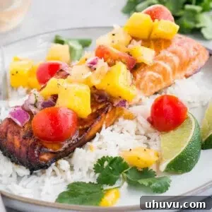 close up image of honey baked salmon with salsa on rice