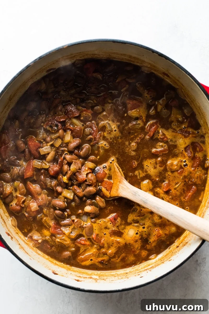 Quick Comfort Pinto Bean Soup 5 Stirring pinto bean soup in a pot