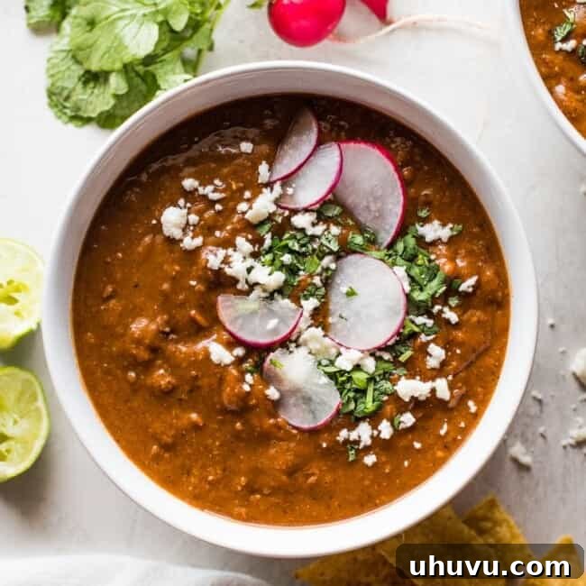 Quick Comfort Pinto Bean Soup 8 Pinto bean soup garnished with cilantro a cotija cheese.