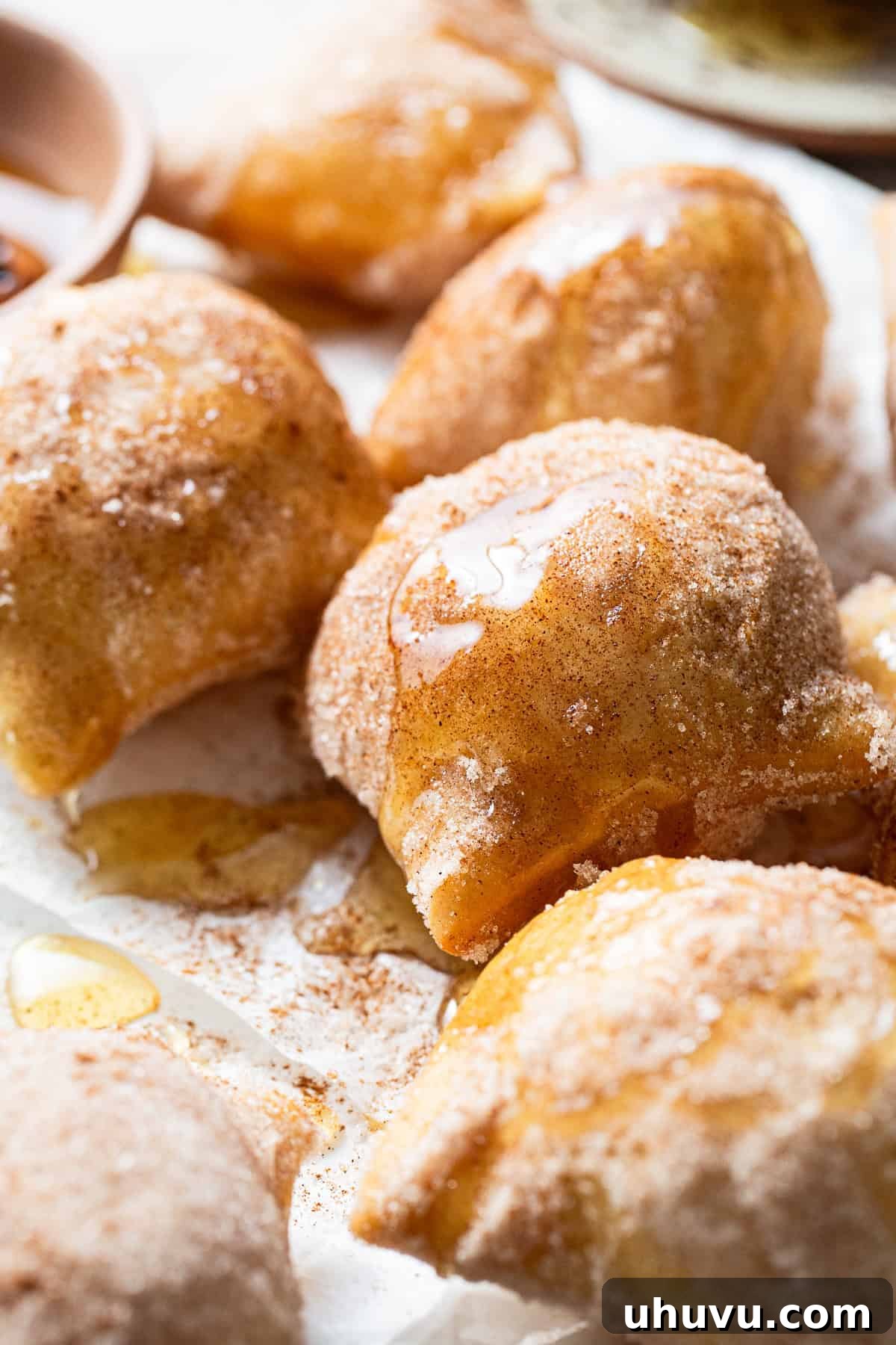 Freshly fried sopapillas covered in honey and cinnamon sugar, ready to be enjoyed.