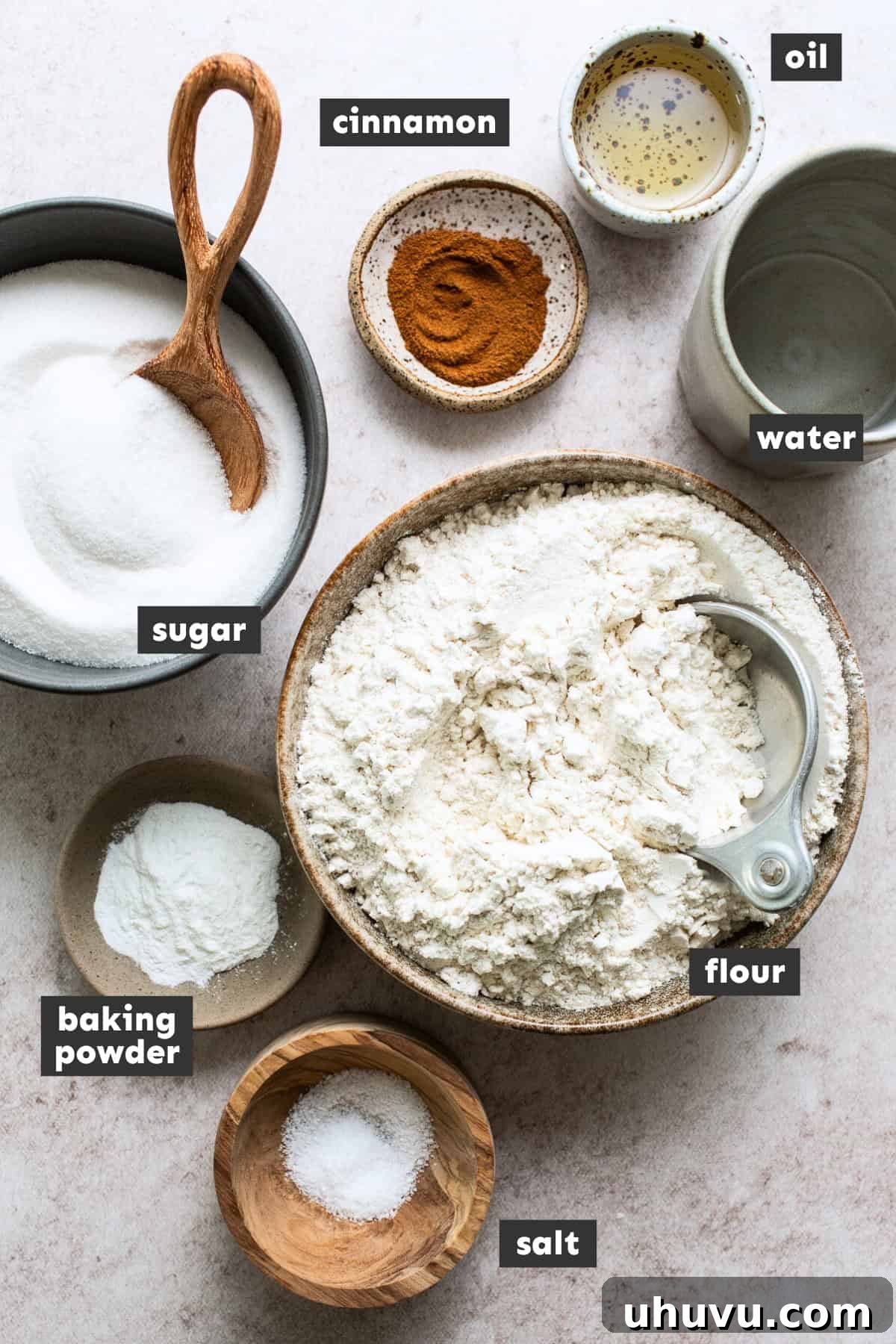 All sopapilla ingredients meticulously measured out into individual bowls on a kitchen counter, ready for preparation.