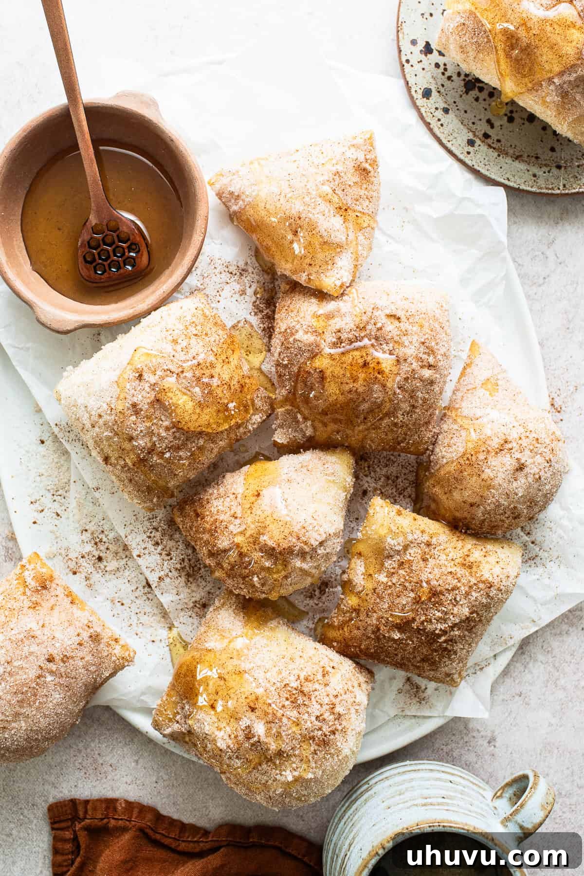 A beautifully presented plate of sopapillas, generously drizzled with honey and ready for serving.